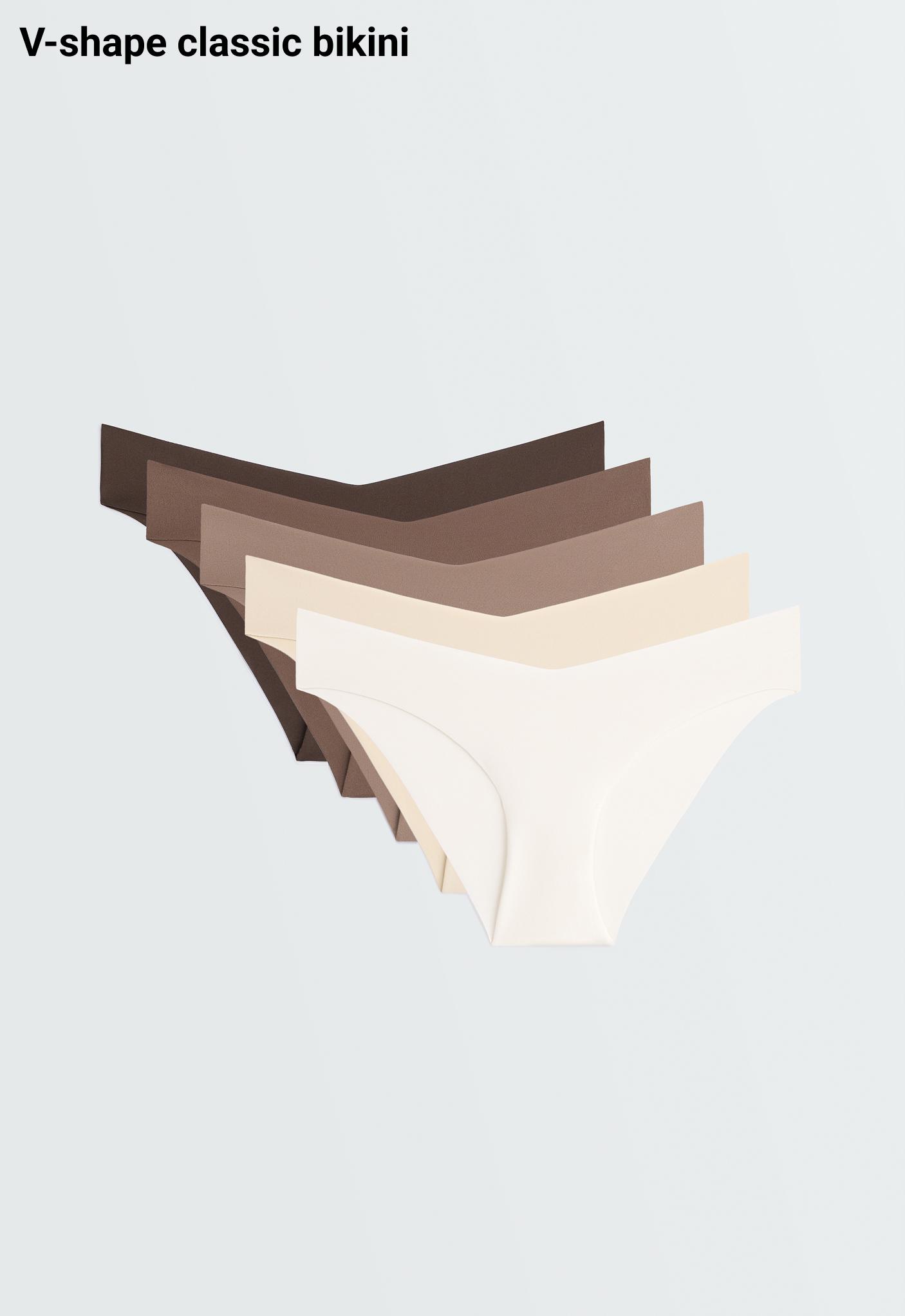 Front view of five seamless panties stacked in brown, beige, and vanilla shades, featuring a V-shaped waistband.