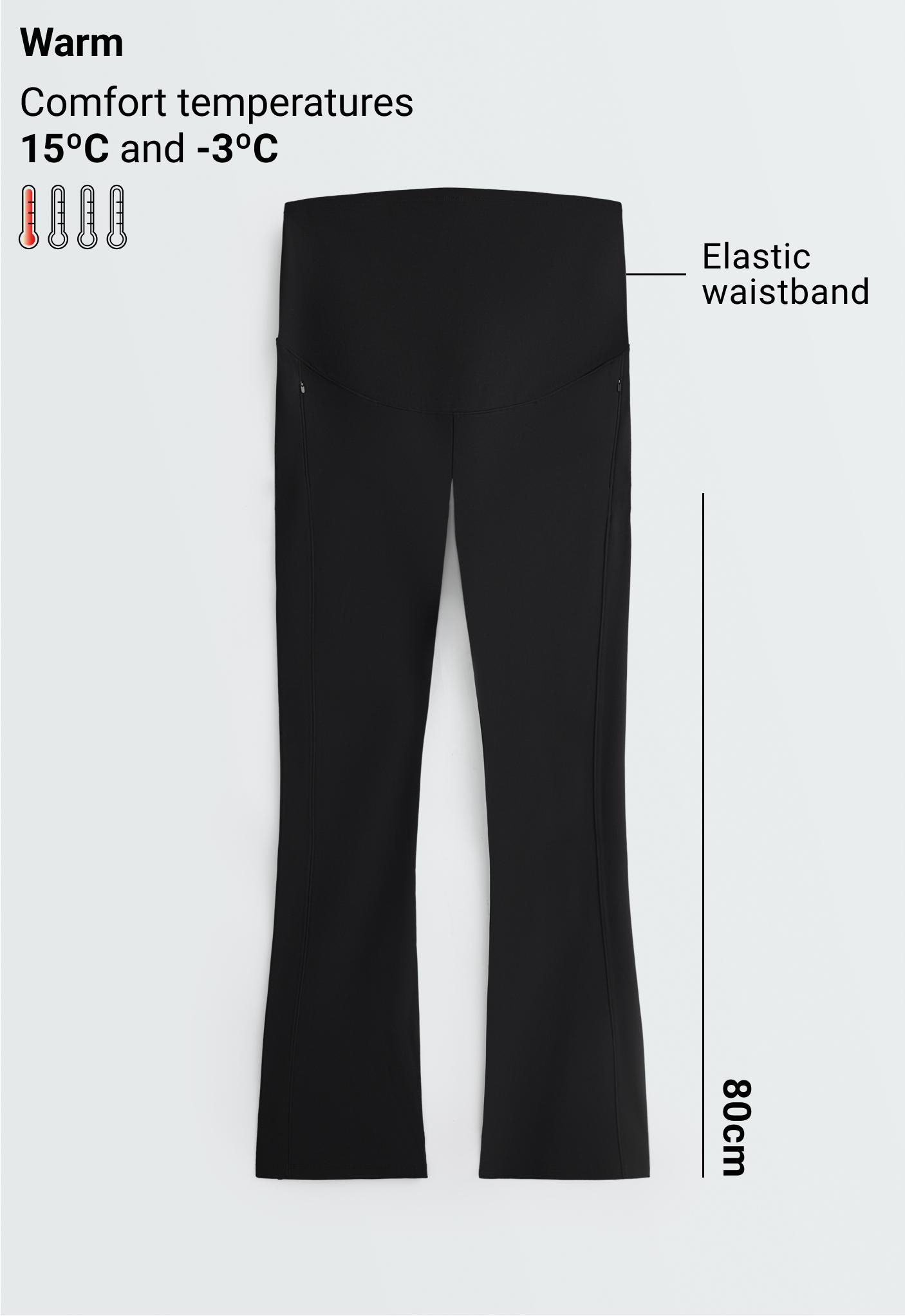 Front view of black flared pants with a high elastic waistband, front zippered pockets, and vertical seams.
