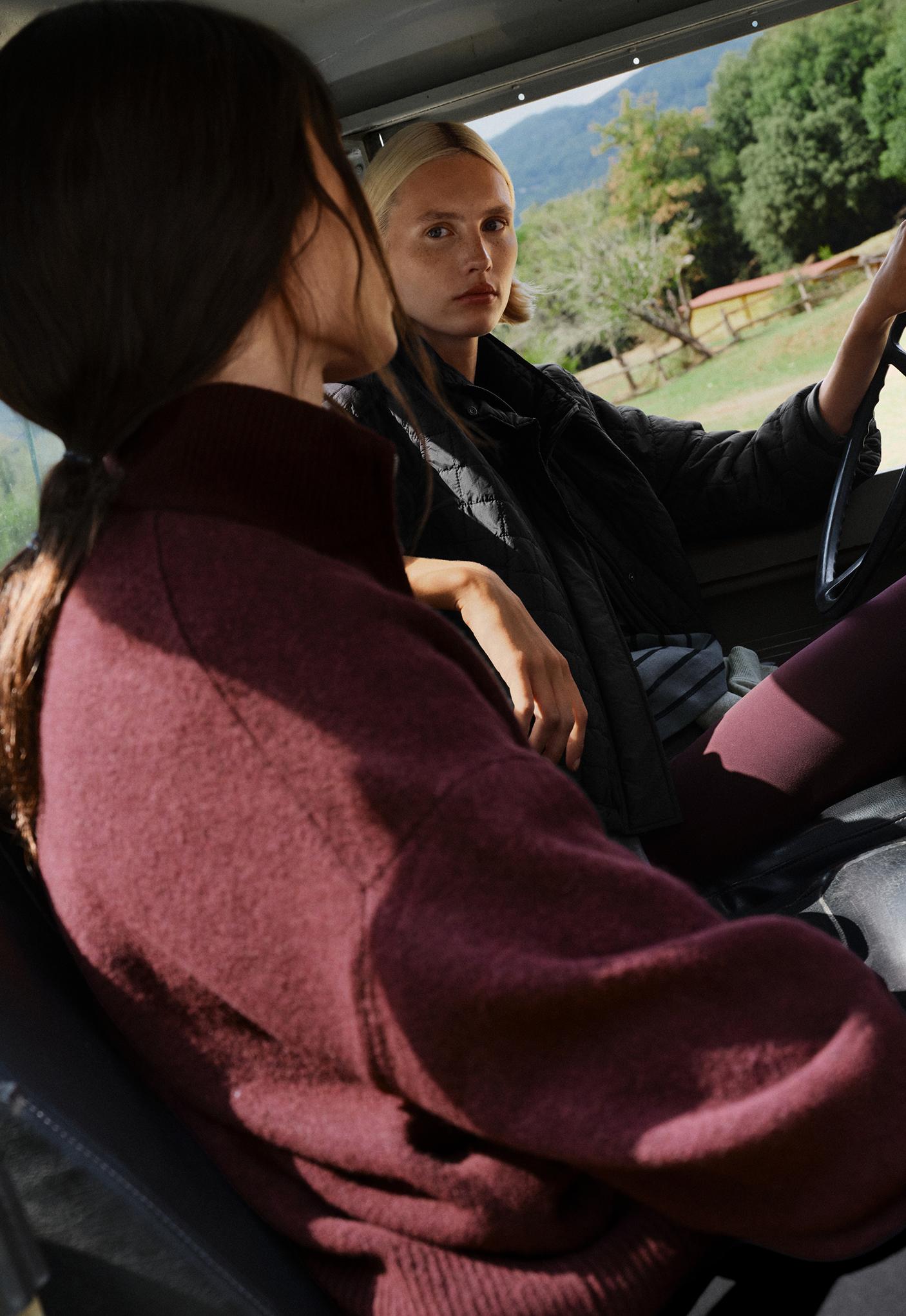 Medium shot of a burgundy turtleneck sweater with long sleeves. It features rib-knit finishes at the cuffs and hem.