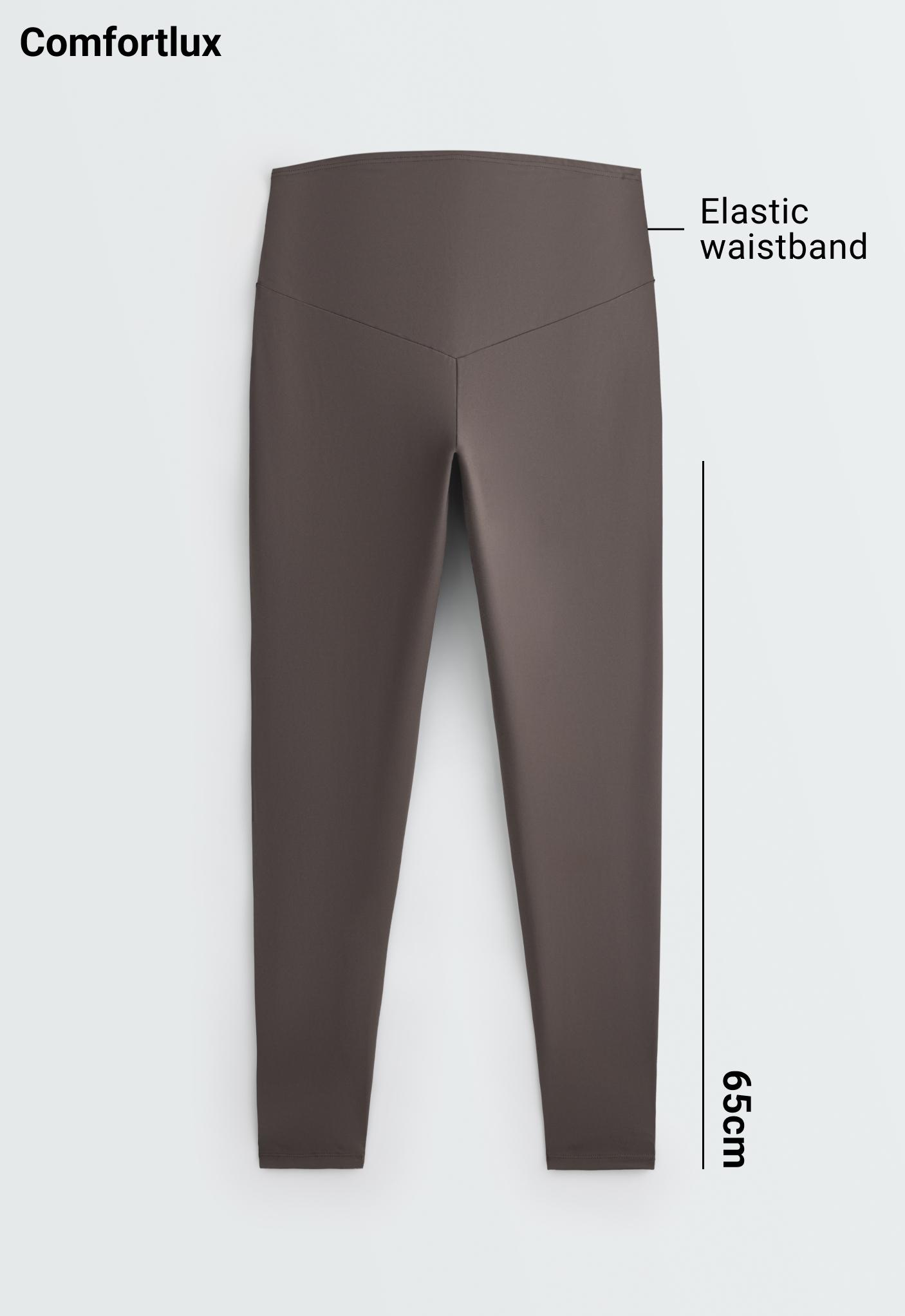 Back view of brown leggings with V-seam. Text: 'Comfortlux', 'Elastic waistband', '65cm'.