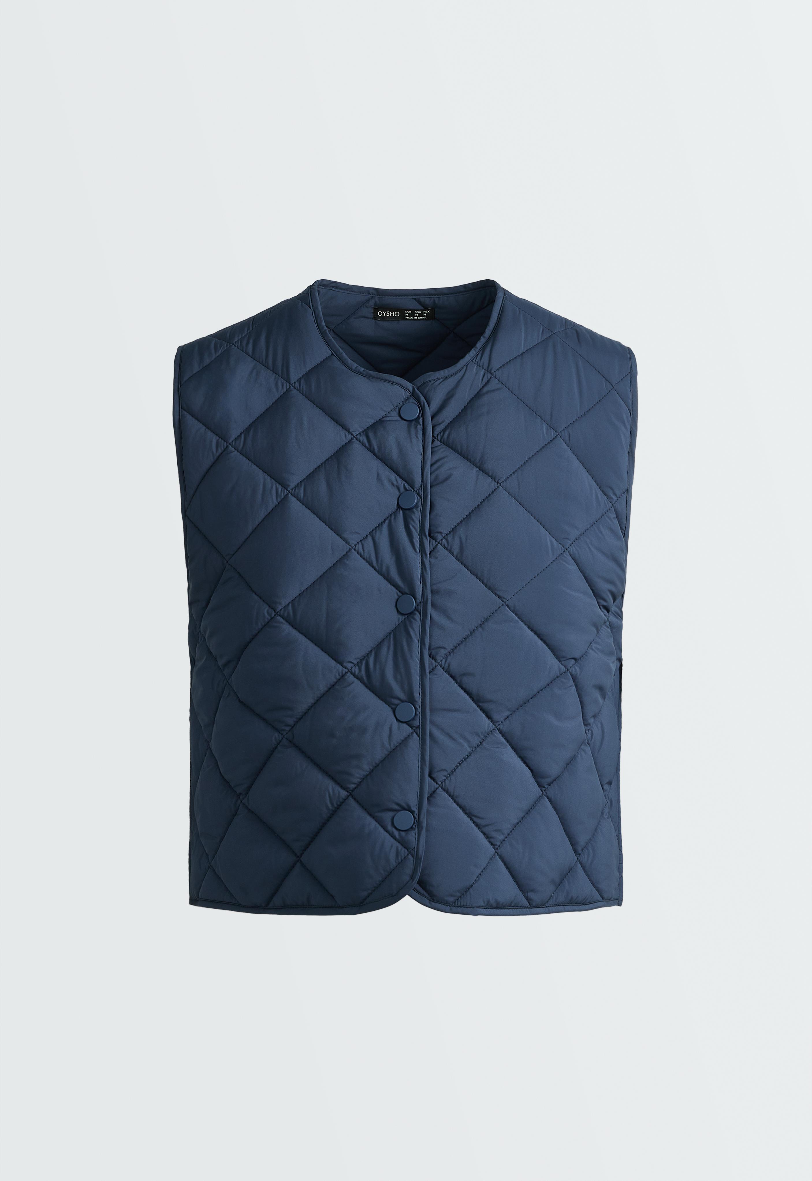 Front view of a navy blue vest with a diamond quilted design, crew neck, and snap button front closure.