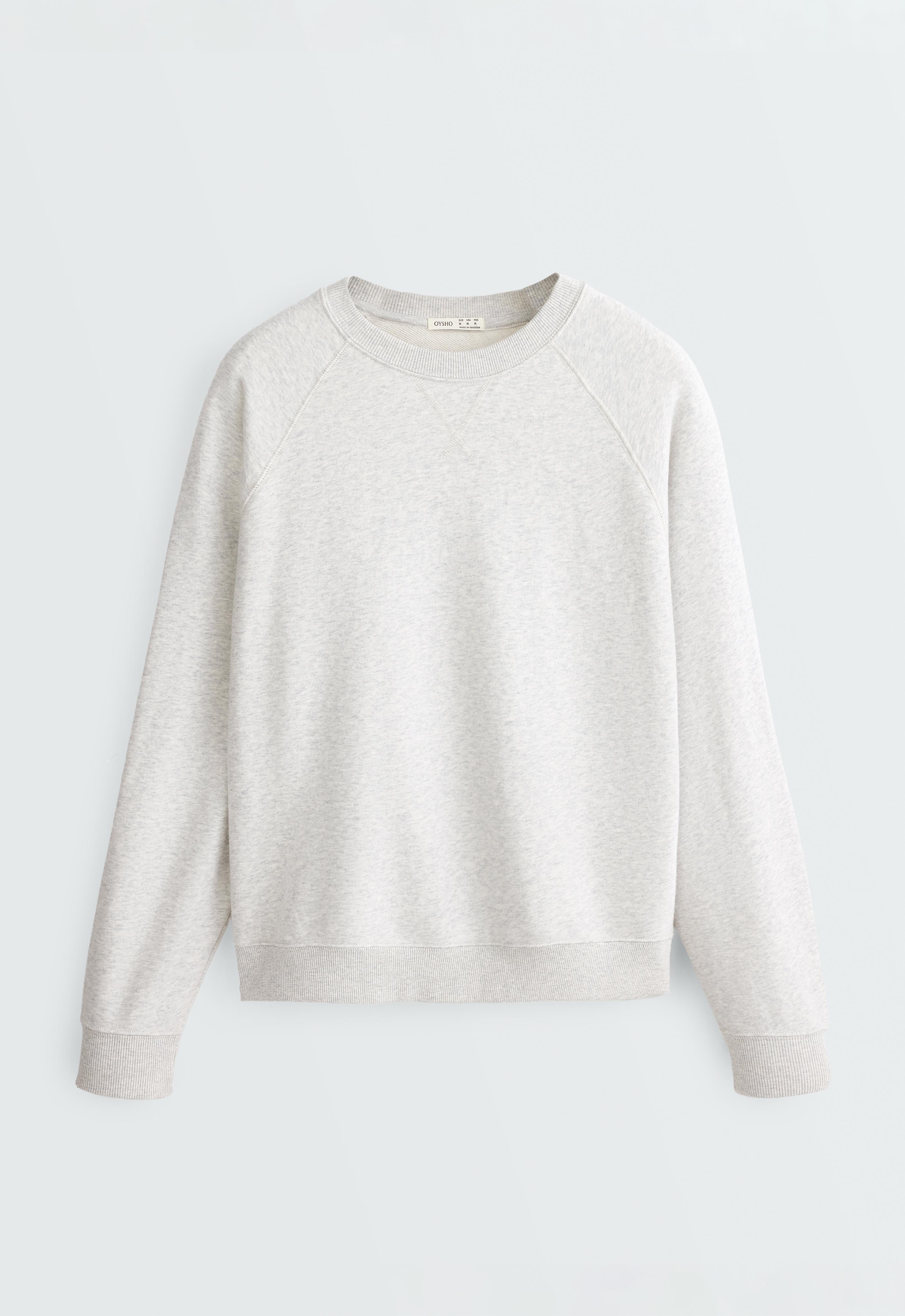 Front view of a light gray heathered sweatshirt with a crew neck, long raglan sleeves, and ribbed cuffs and hem.