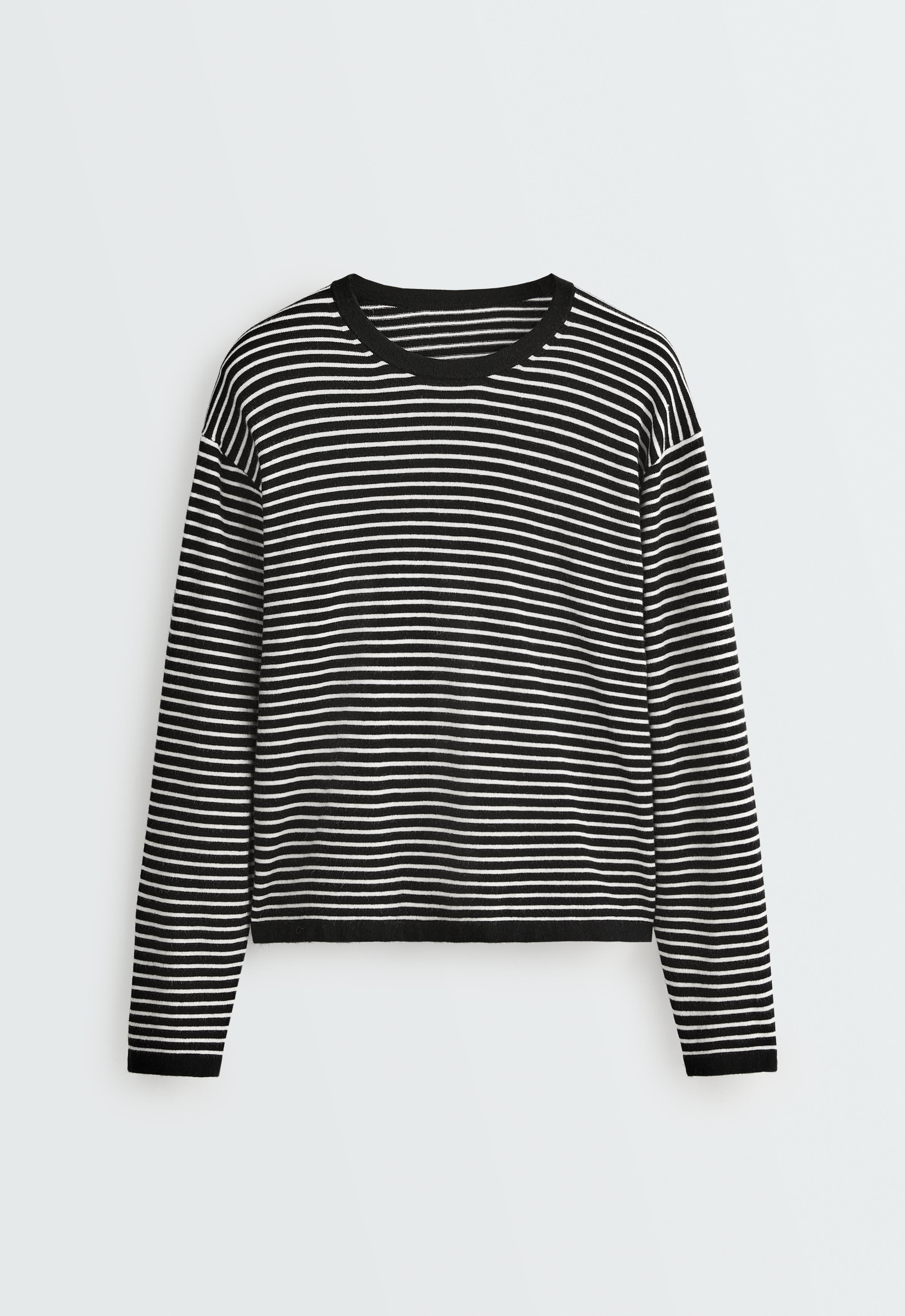 Front view of a black sweater with white horizontal stripes, a crew neck, long sleeves, and black trim.