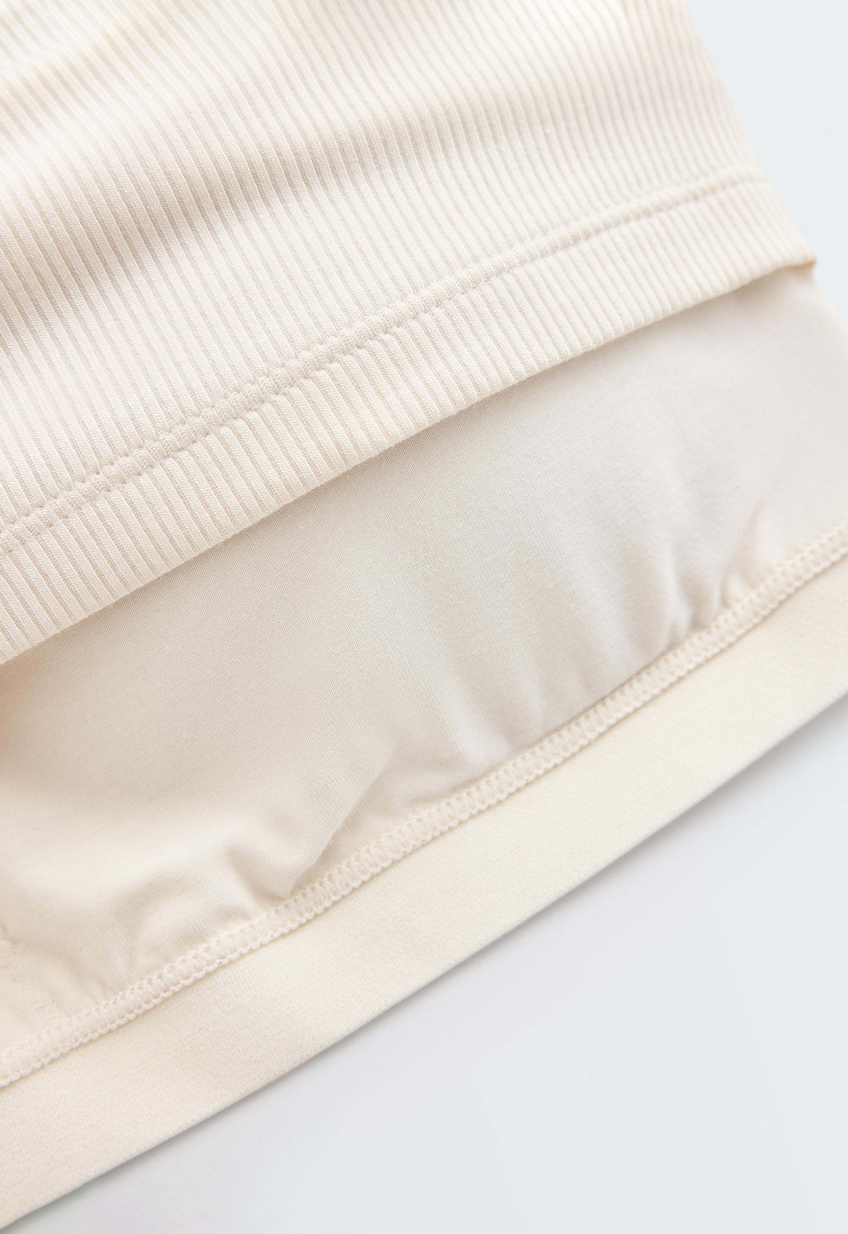 Sleeveless seamless rib tank top with half-zip — PALE ECRU