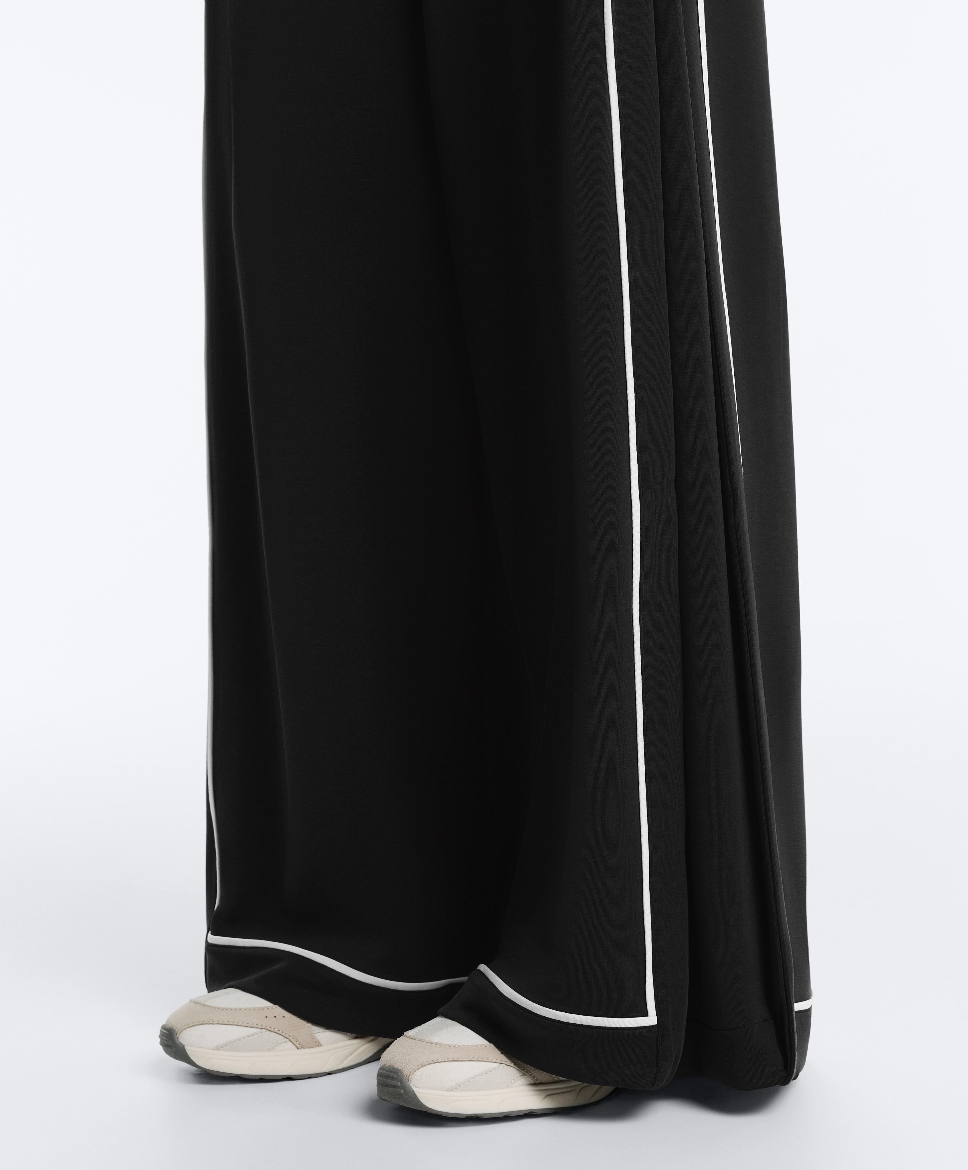 Soft-touch modal wide-leg trousers with contrast piping — BLACK