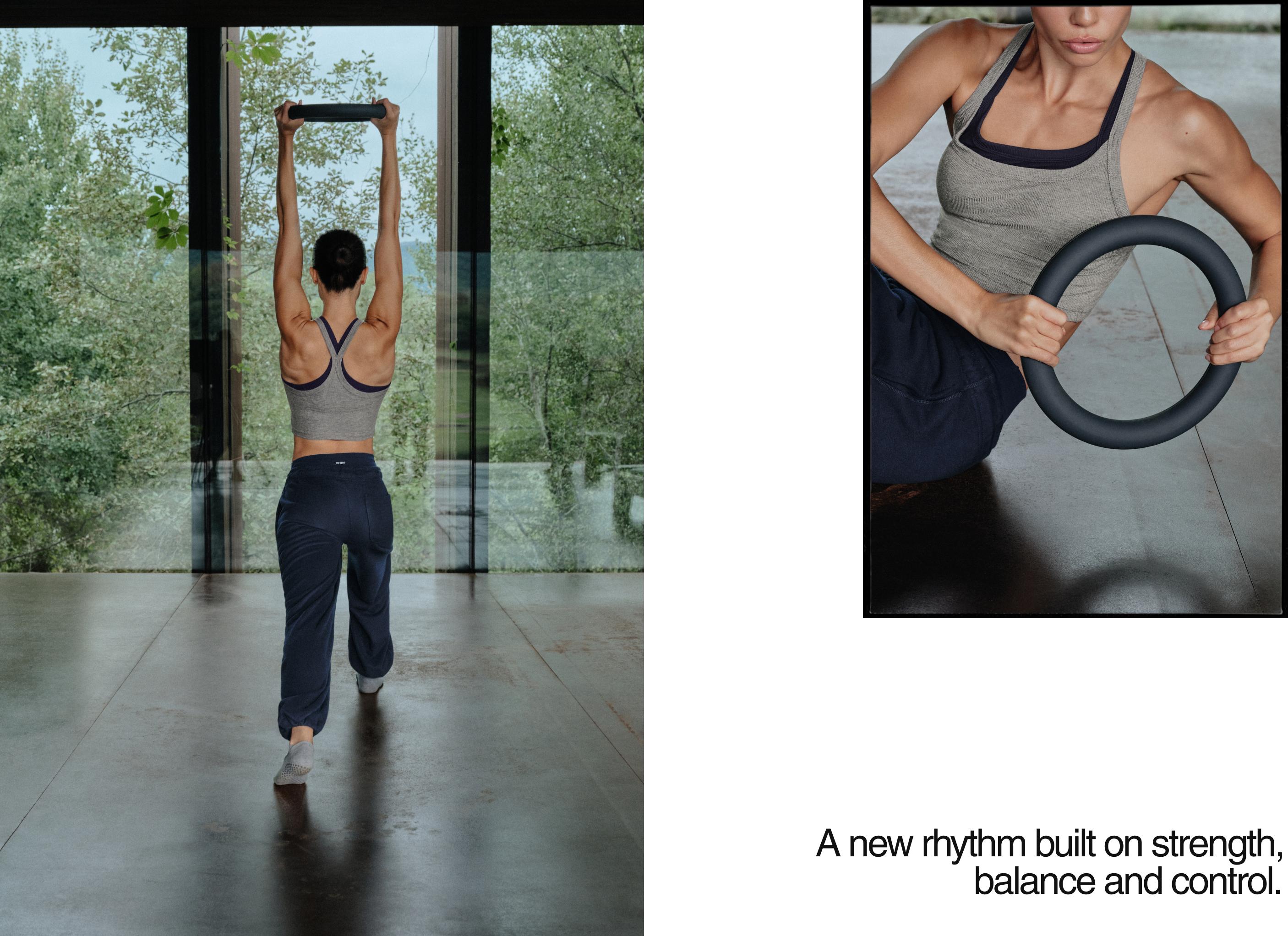 Gray marled top set with contrasting navy blue crisscross straps and navy blue sweatpants.