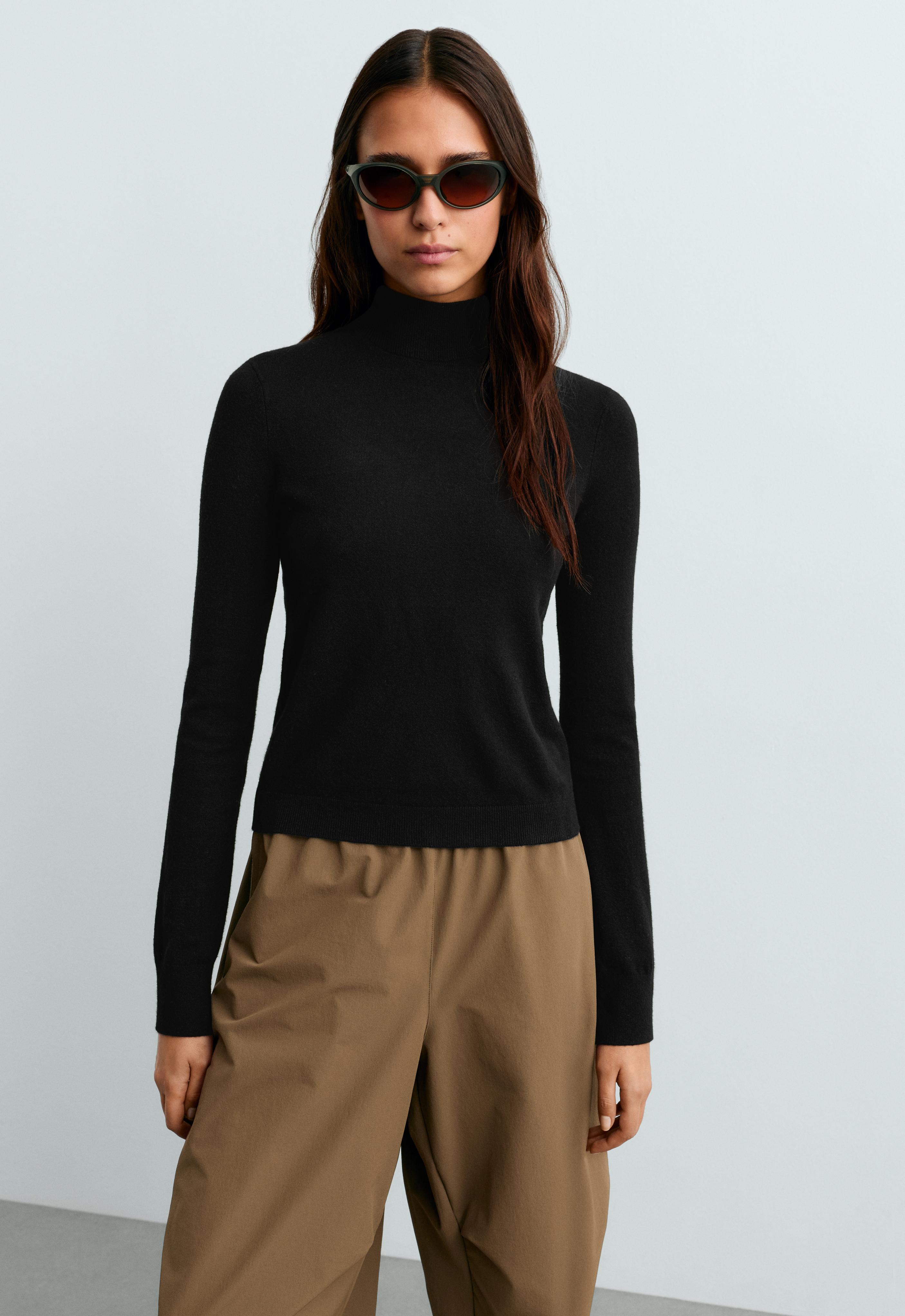Black long-sleeve knit set with a mock neck, brown pants, and sunglasses. — photo 1 of 1