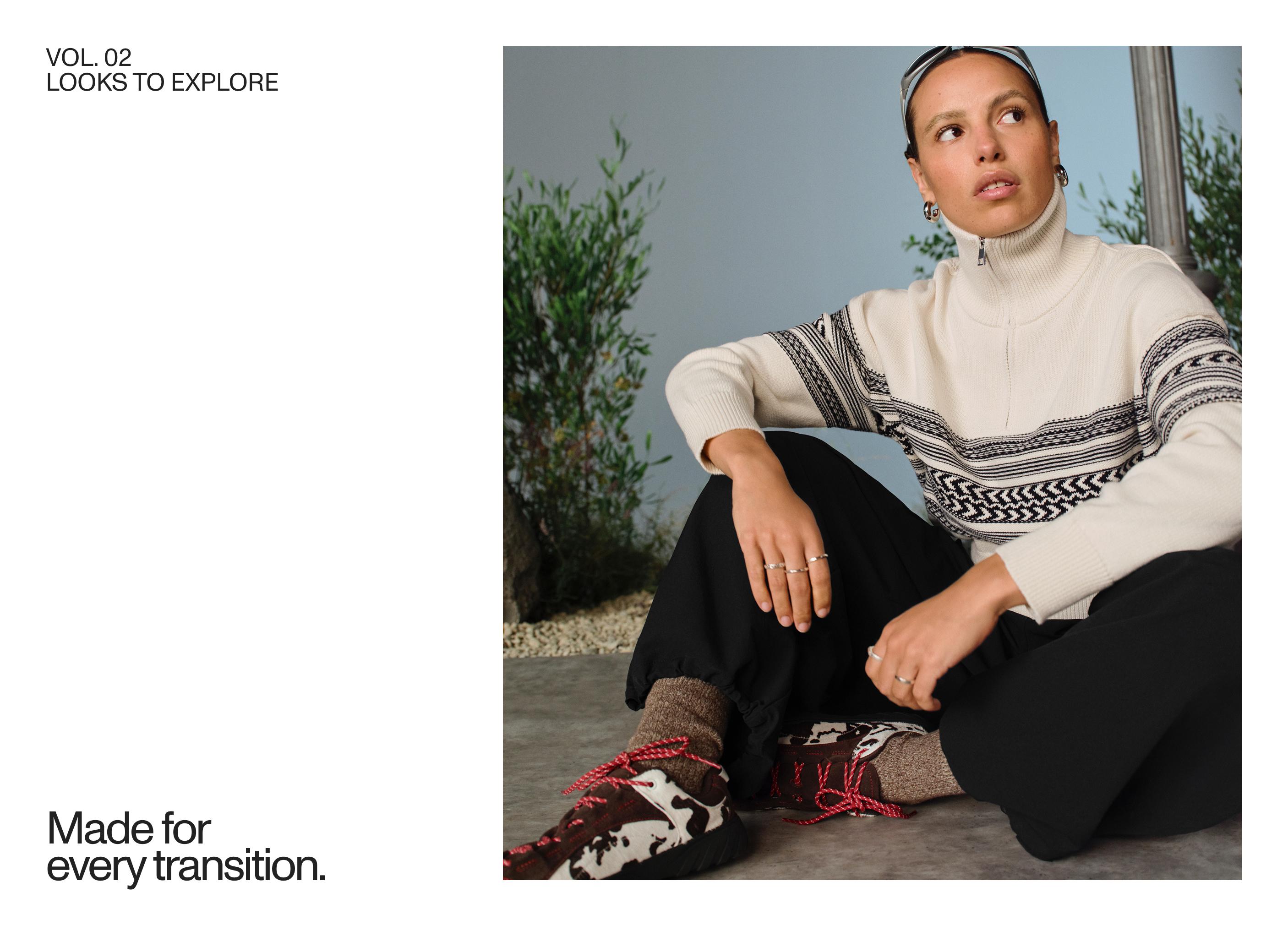 White jersey set with a zipper and black trim, black pants, and animal-print sneakers with red laces.