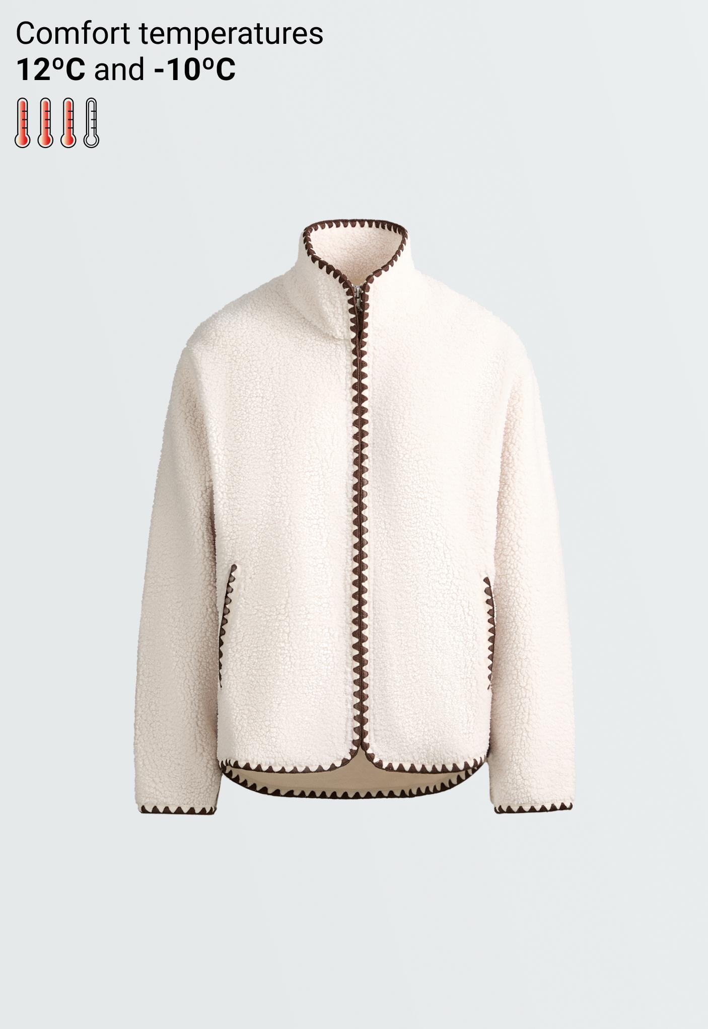 Front view of a jacket with a high collar, zip closure, side pockets, and contrasting stitching.